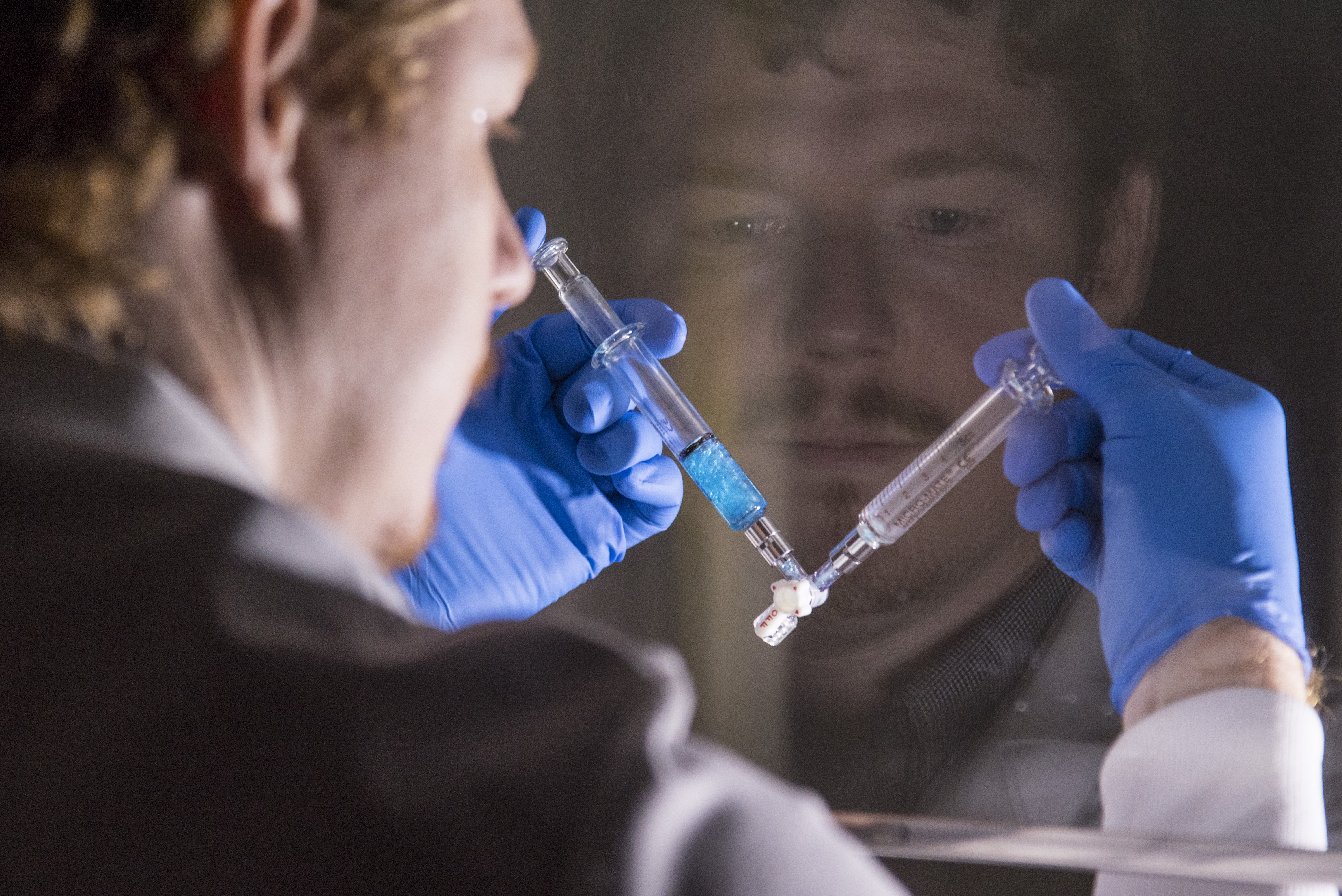 Dr. Jim Nichols mixes a solution in a laboratory 